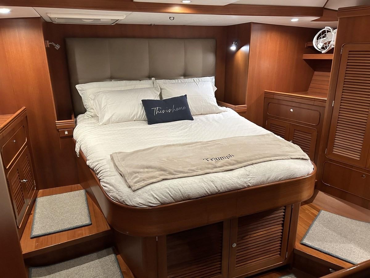 a bed with white sheets aboard TRIUMPH Yacht for Sale