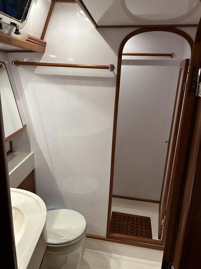 a bathroom with a glass shower aboard TRIUMPH Yacht for Sale