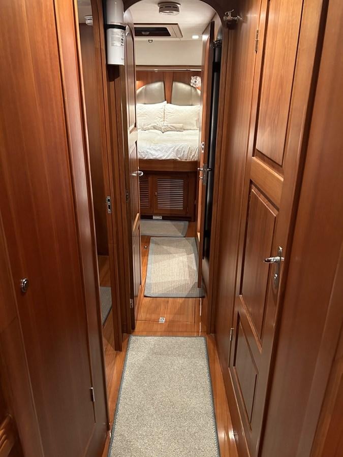 a room with a bed and a door aboard TRIUMPH Yacht for Sale