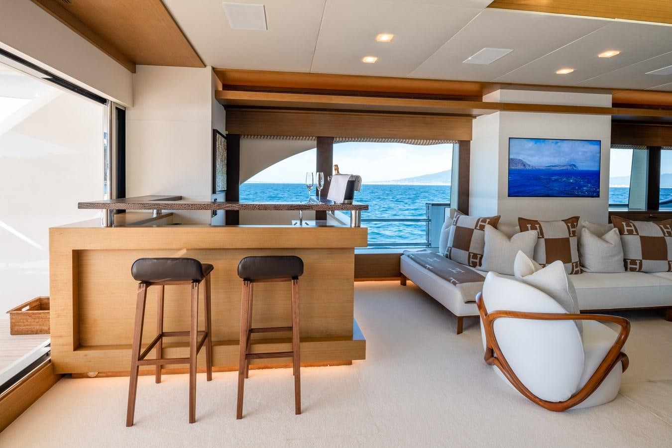 a room with a couch and a table and chairs aboard QUANTUM H Yacht for Sale