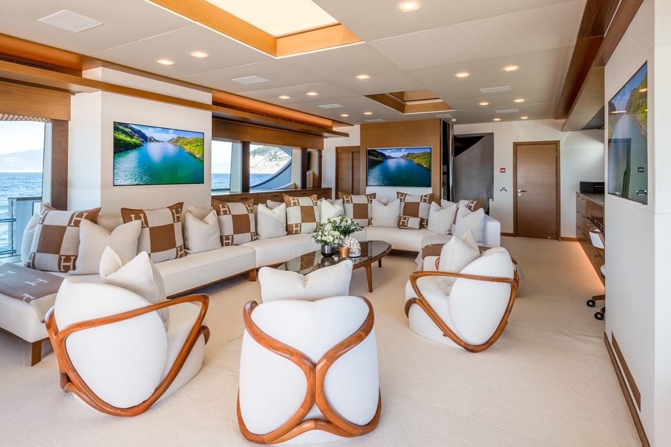 a living room with a large screen aboard QUANTUM H Yacht for Sale