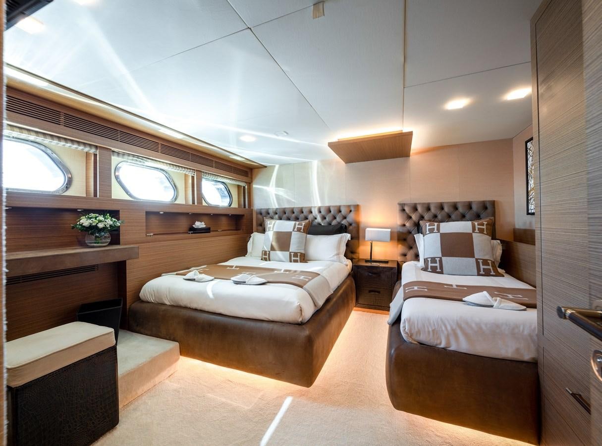a bedroom with a bed and a desk aboard QUANTUM H Yacht for Sale