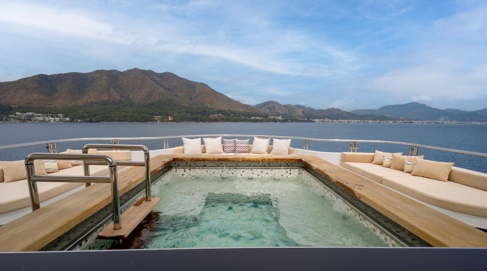 a pool on a deck overlooking a beach aboard M 47 Yacht for Sale