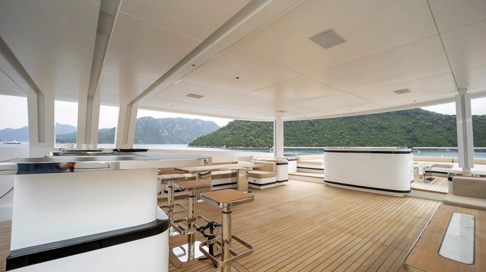 a room with tables and chairs aboard M 47 Yacht for Sale