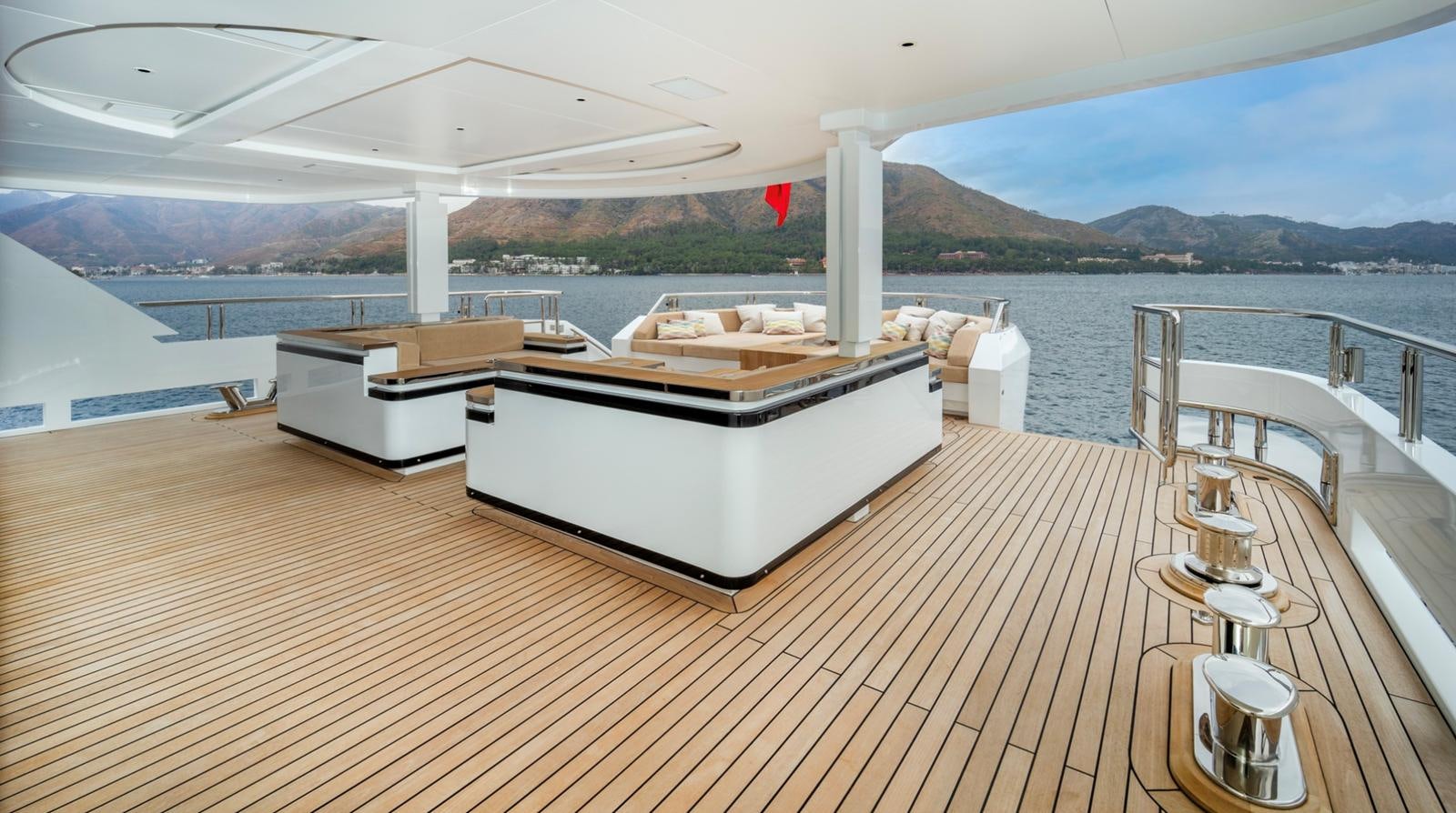 a deck with a large white lounge chair and a large body of water aboard M 47 Yacht for Sale
