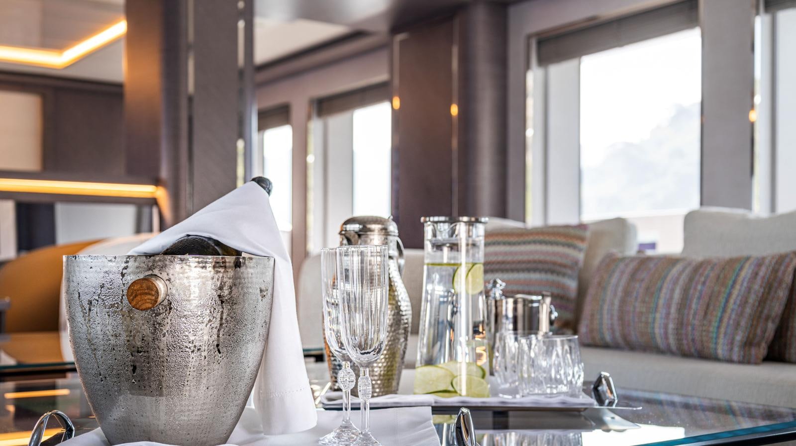 a table with glasses and a pot aboard M 47 Yacht for Sale