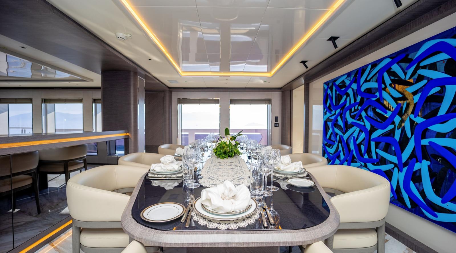 a dining room with a large decorated cake on a round white table aboard M 47 Yacht for Sale