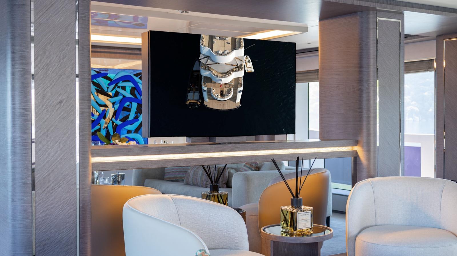 a room with a tv and chairs aboard M 47 Yacht for Sale