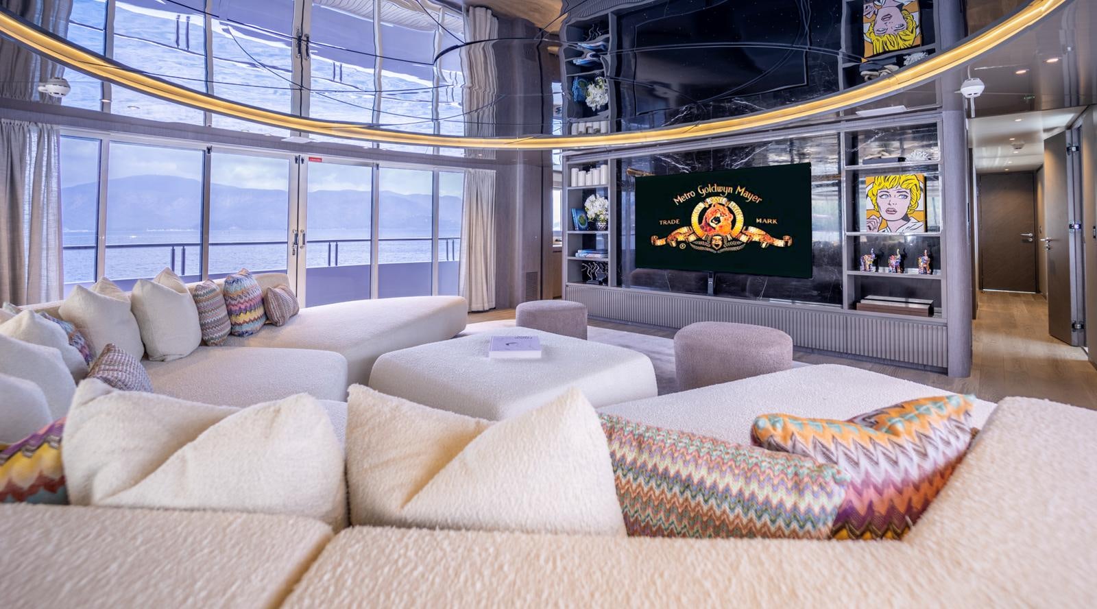 a living room with a large screen aboard M 47 Yacht for Sale