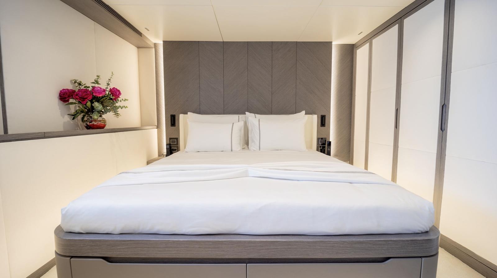 a bed with white sheets and pillows aboard M 47 Yacht for Sale