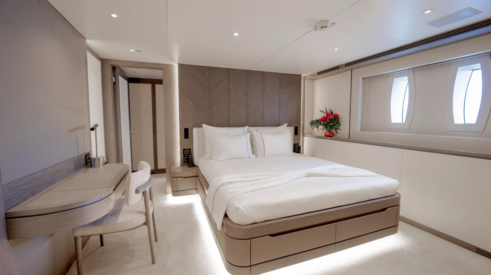 a room with a bed and a chair aboard M 47 Yacht for Sale