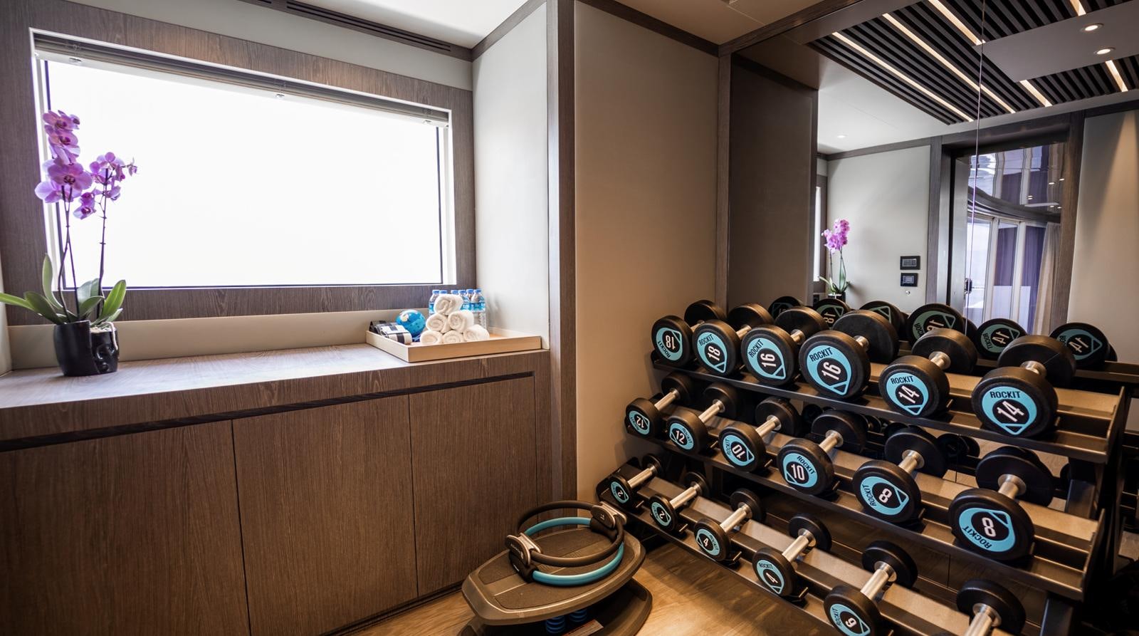 a room with a shelf of watches aboard M 47 Yacht for Sale