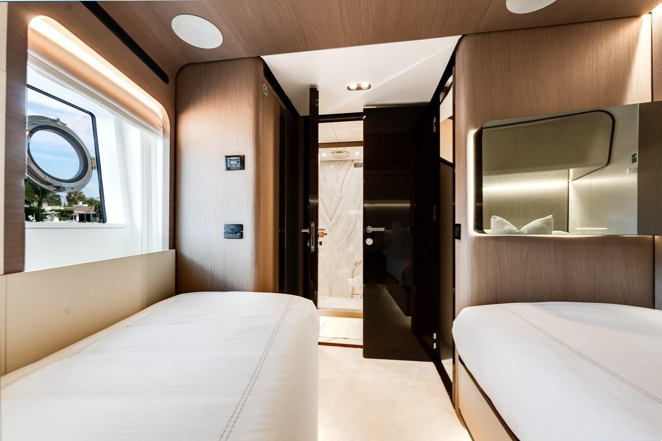 a room with a bed and a mirror aboard DAYBREAK Yacht for Sale