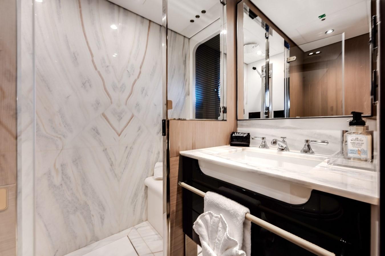 a bathroom with a mirror and a sink aboard DAYBREAK Yacht for Sale