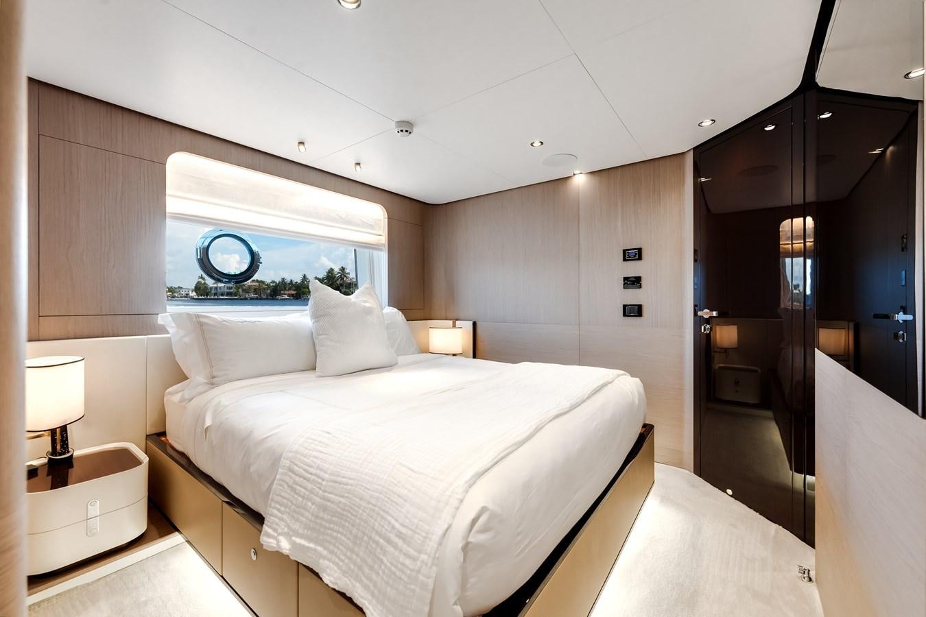 a bedroom with a bed and a mirror aboard DAYBREAK Yacht for Sale