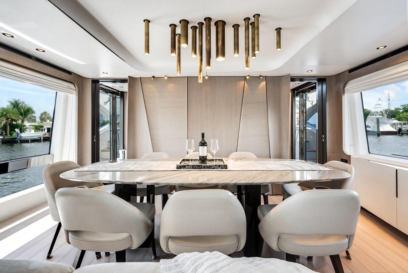 a large kitchen with white chairs aboard DAYBREAK Yacht for Sale