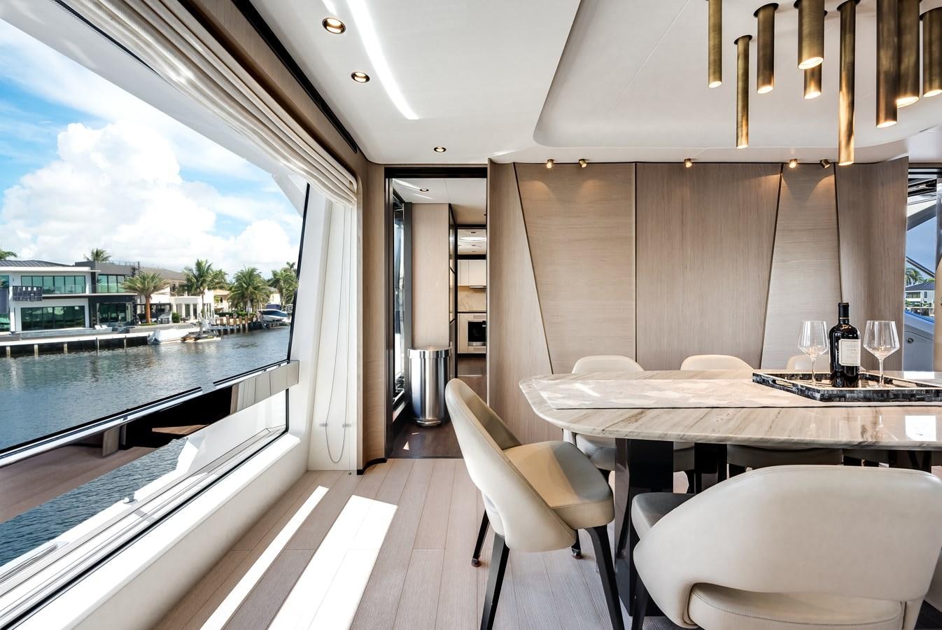 a room with a table chairs and a large window aboard DAYBREAK Yacht for Sale