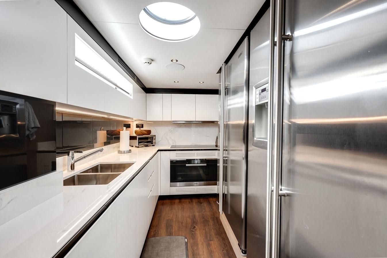 a kitchen with a glass door aboard DAYBREAK Yacht for Sale