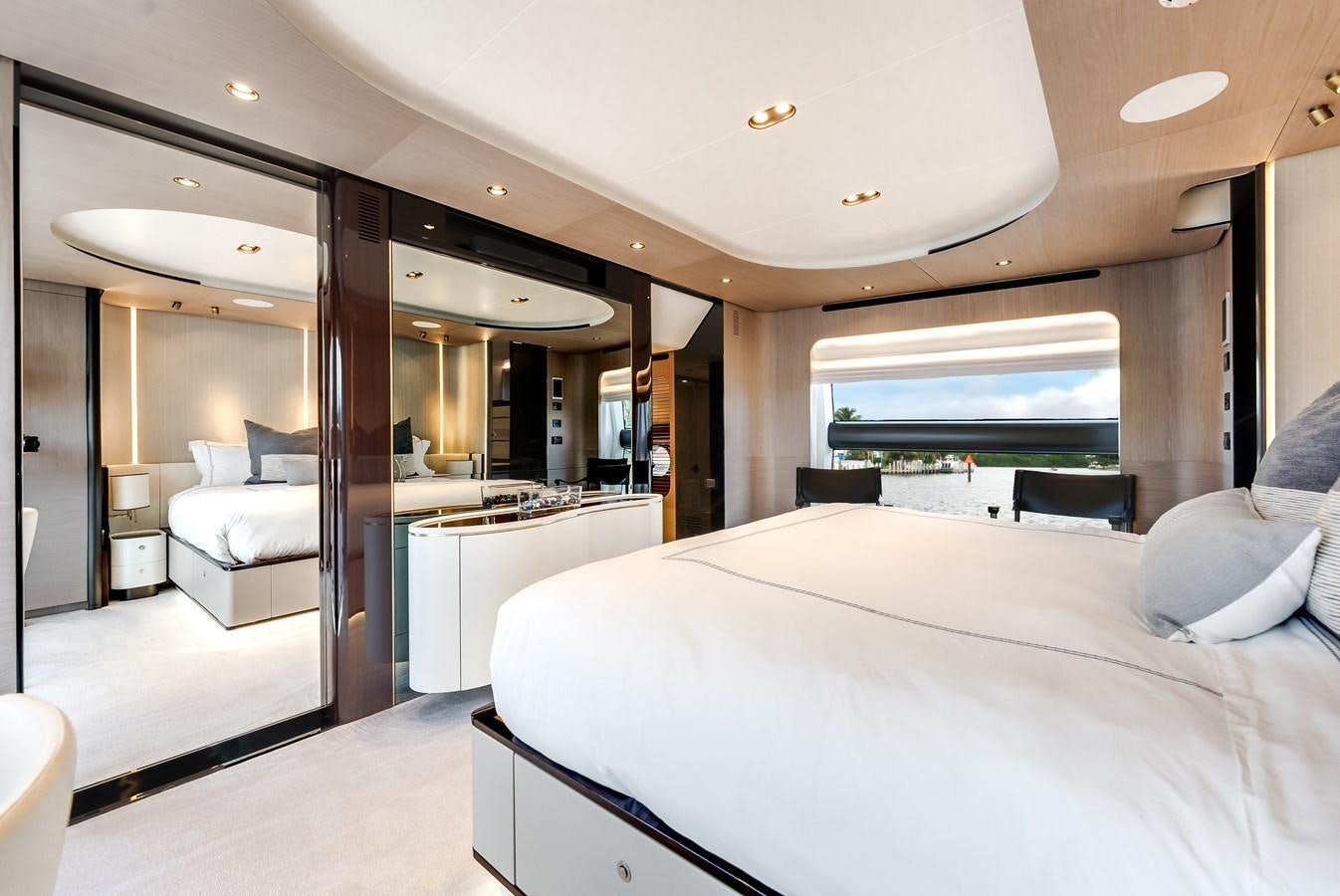 a room with a bed and a large mirror aboard DAYBREAK Yacht for Sale