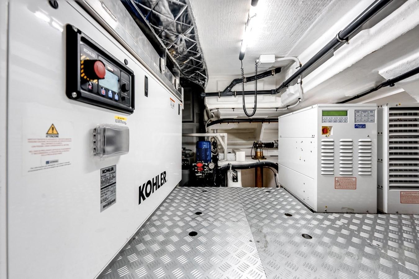 a room with white walls and a large white machine with a screen and buttons and a black and aboard DAYBREAK Yacht for Sale