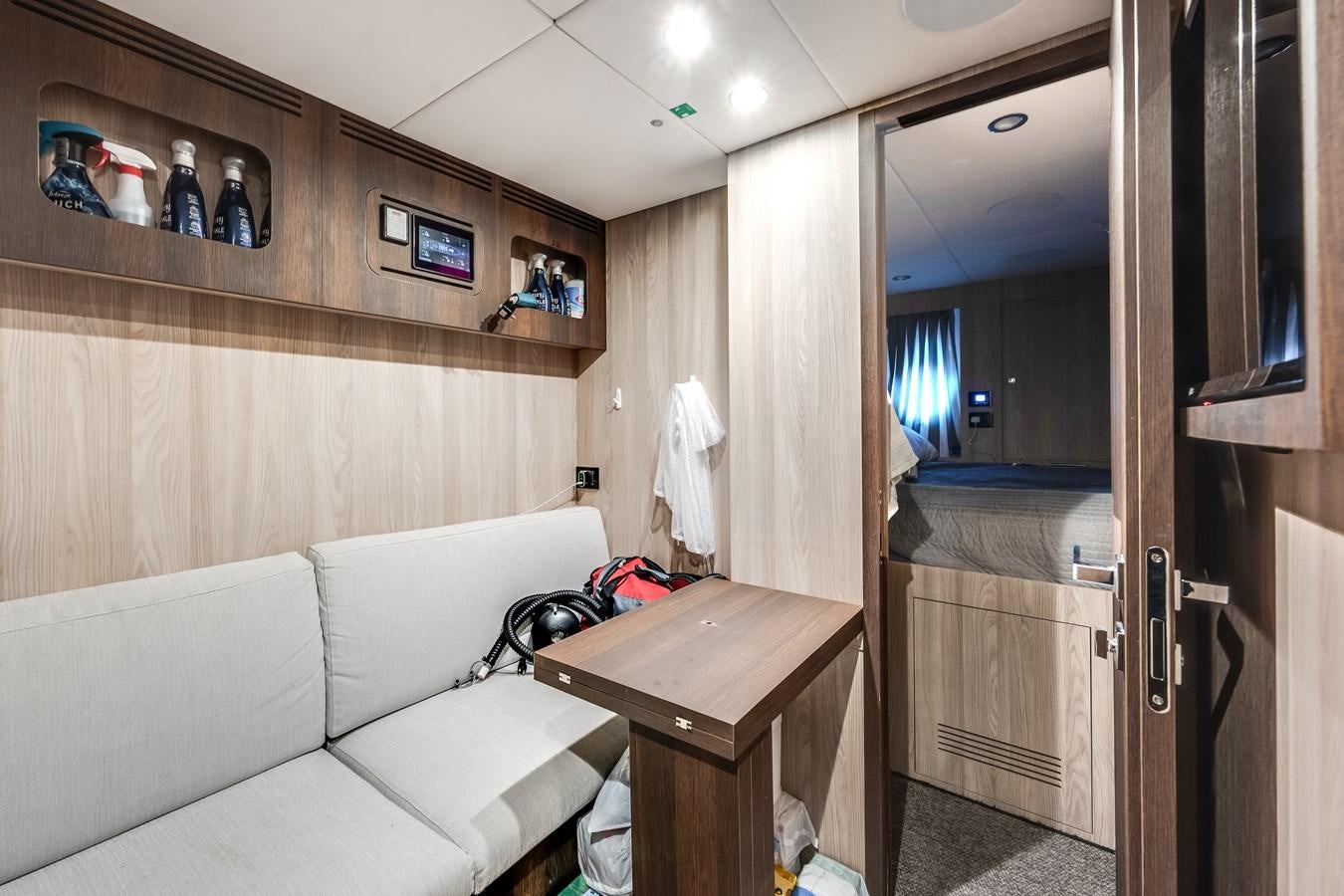 a room with a couch and a mirror aboard DAYBREAK Yacht for Sale
