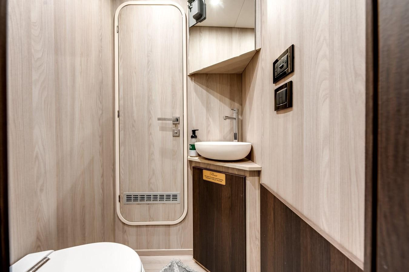 a bathroom with a sink and a shower aboard DAYBREAK Yacht for Sale