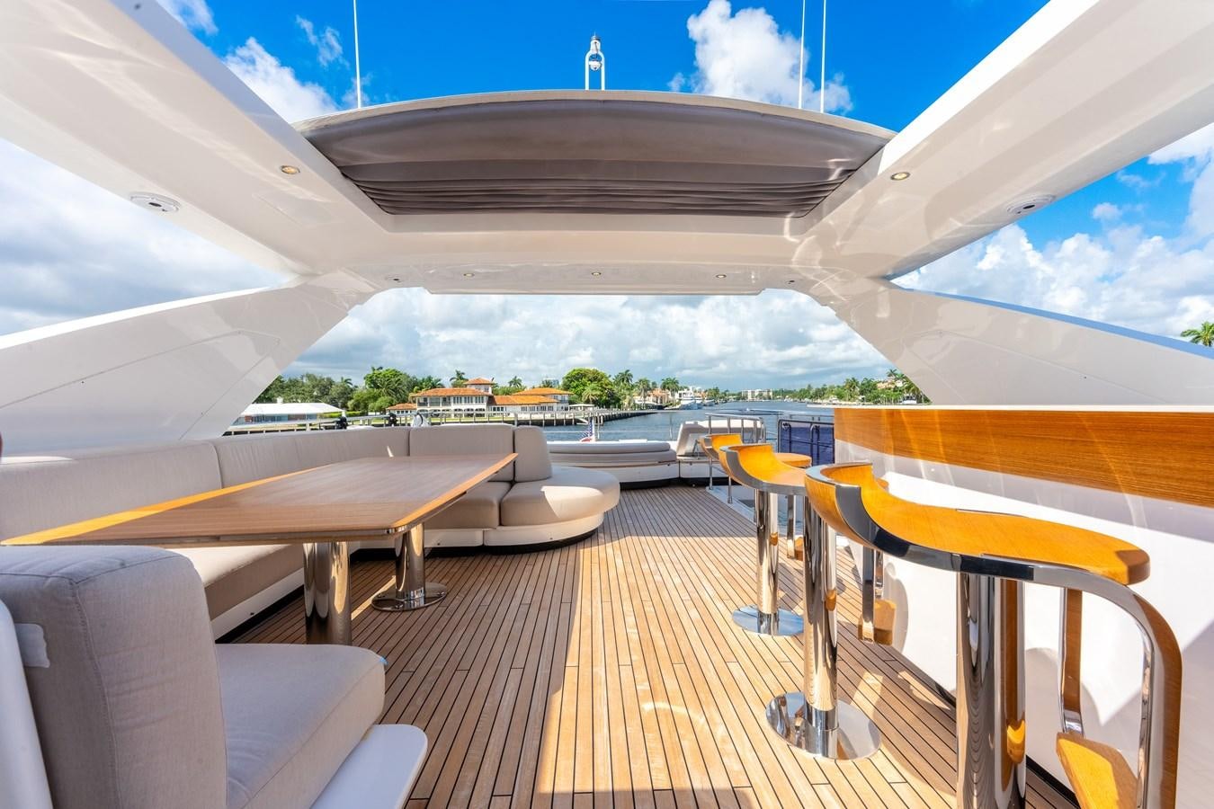 a deck with a large building and a pool aboard DAYBREAK Yacht for Sale