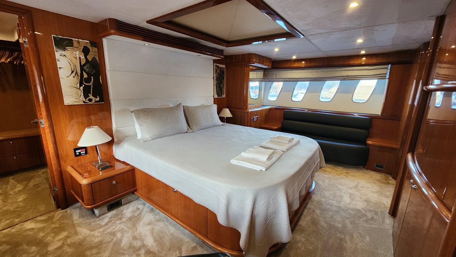 a room with a bed and a desk aboard SPACE ODDITY Yacht for Sale