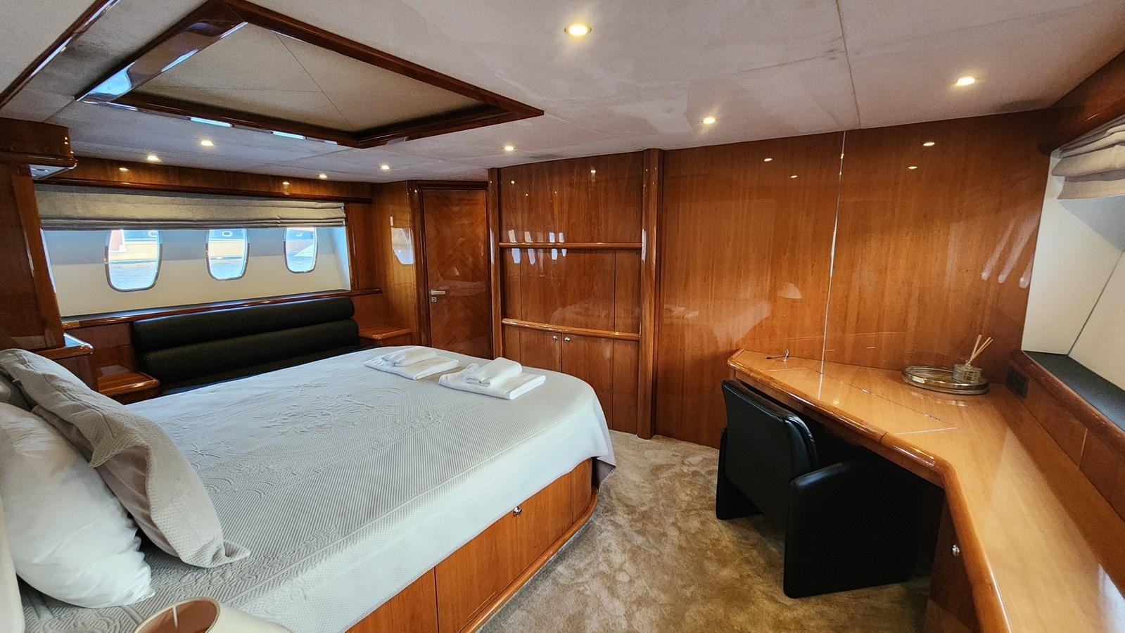 a room with a bed and a desk aboard SPACE ODDITY Yacht for Sale