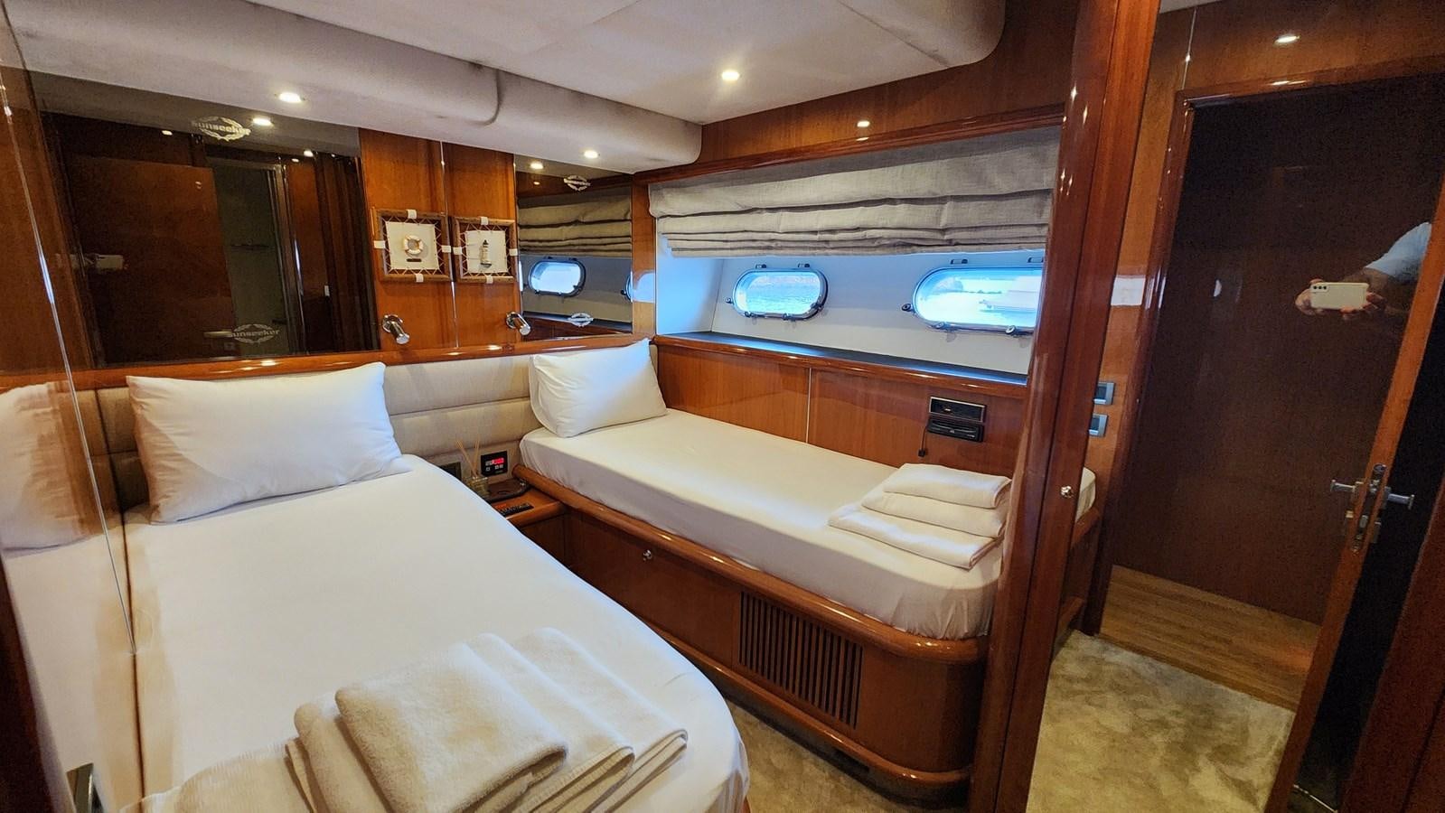 a room with a bed and a television aboard SPACE ODDITY Yacht for Sale