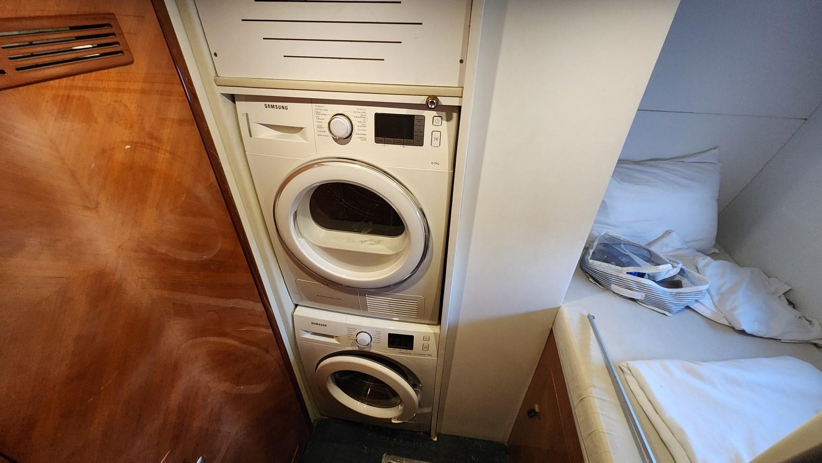 a washing machine in a room aboard SPACE ODDITY Yacht for Sale
