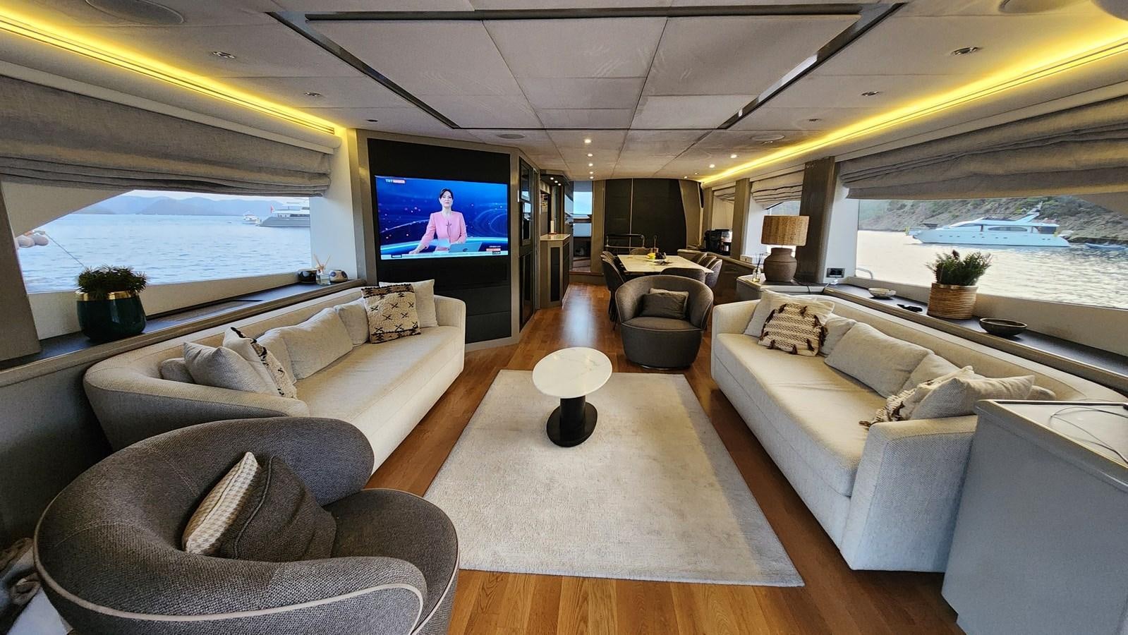 a living room with a large screen aboard SPACE ODDITY Yacht for Sale