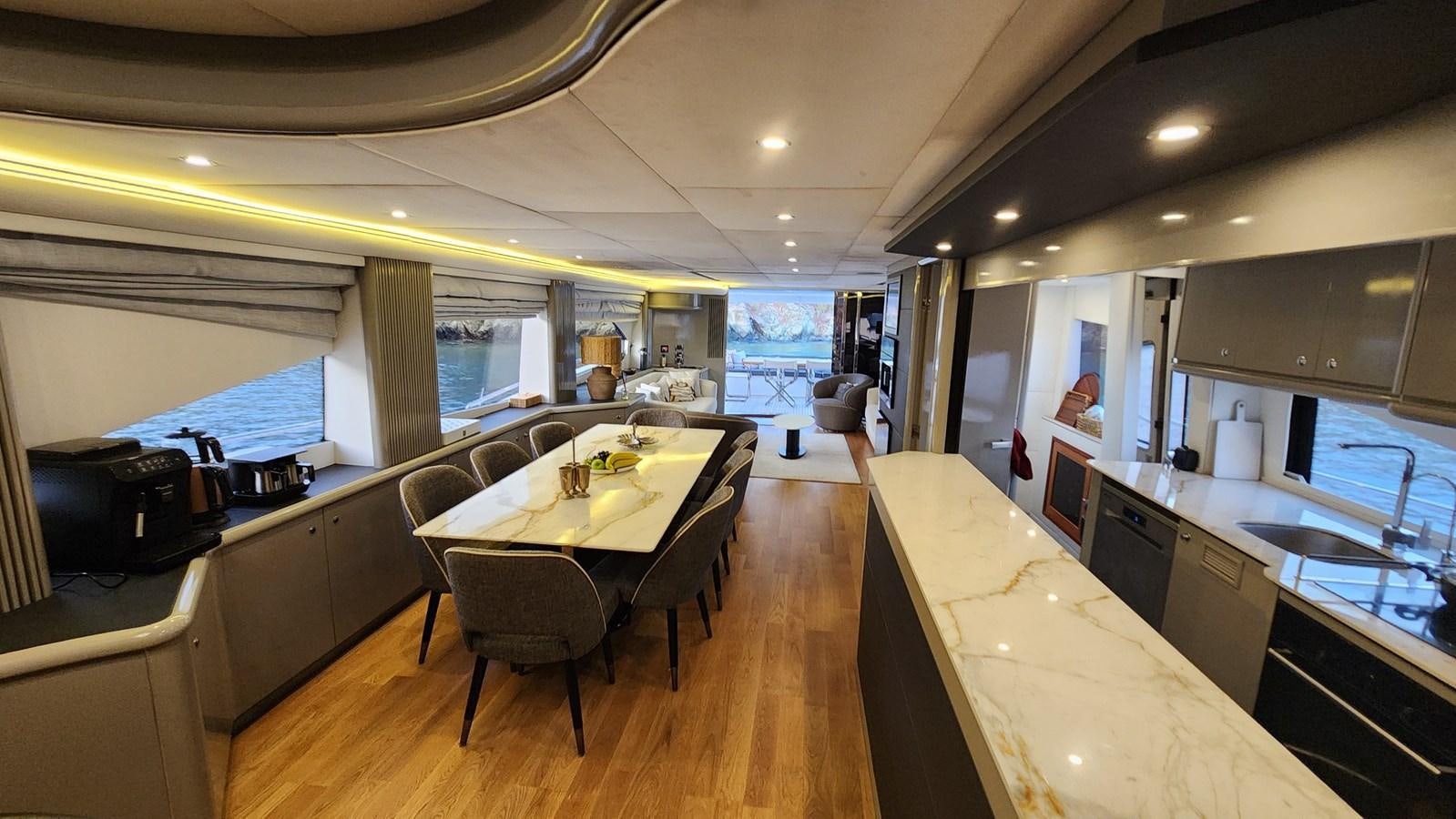 a kitchen with a table and chairs aboard SPACE ODDITY Yacht for Sale