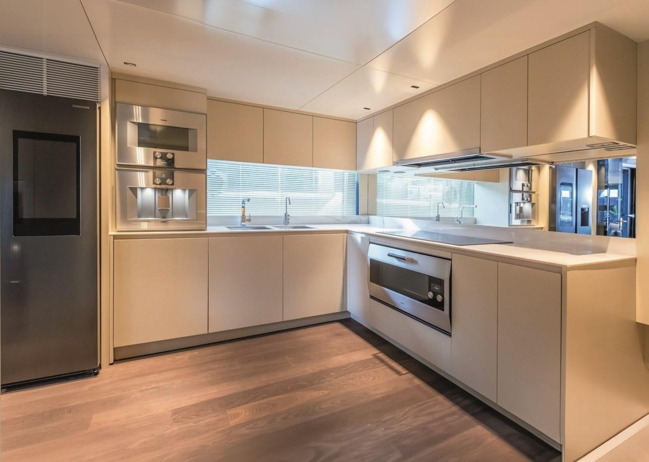 a kitchen with white cabinets aboard NADA Yacht for Sale