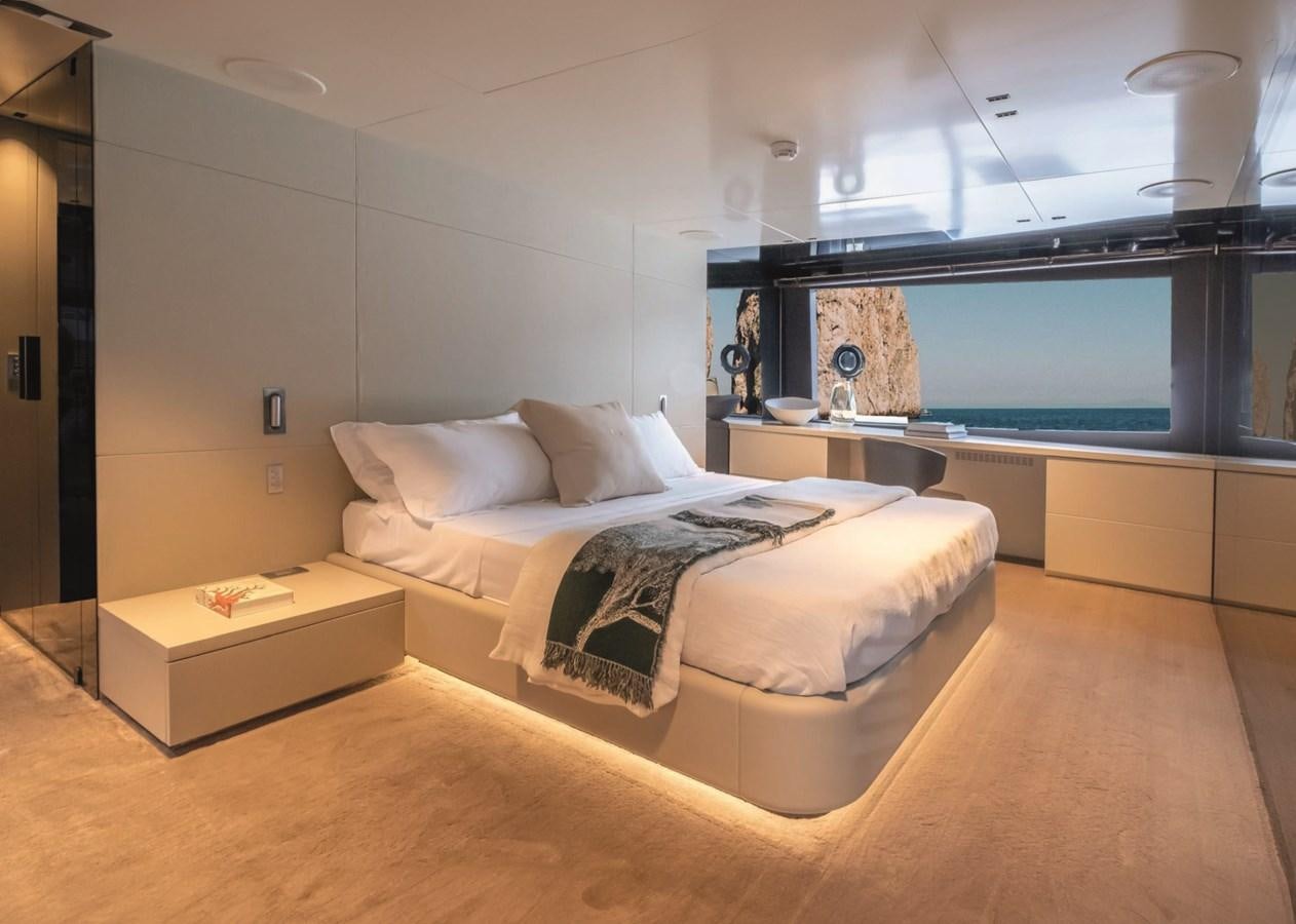 a room with a bed and a desk aboard NADA Yacht for Sale