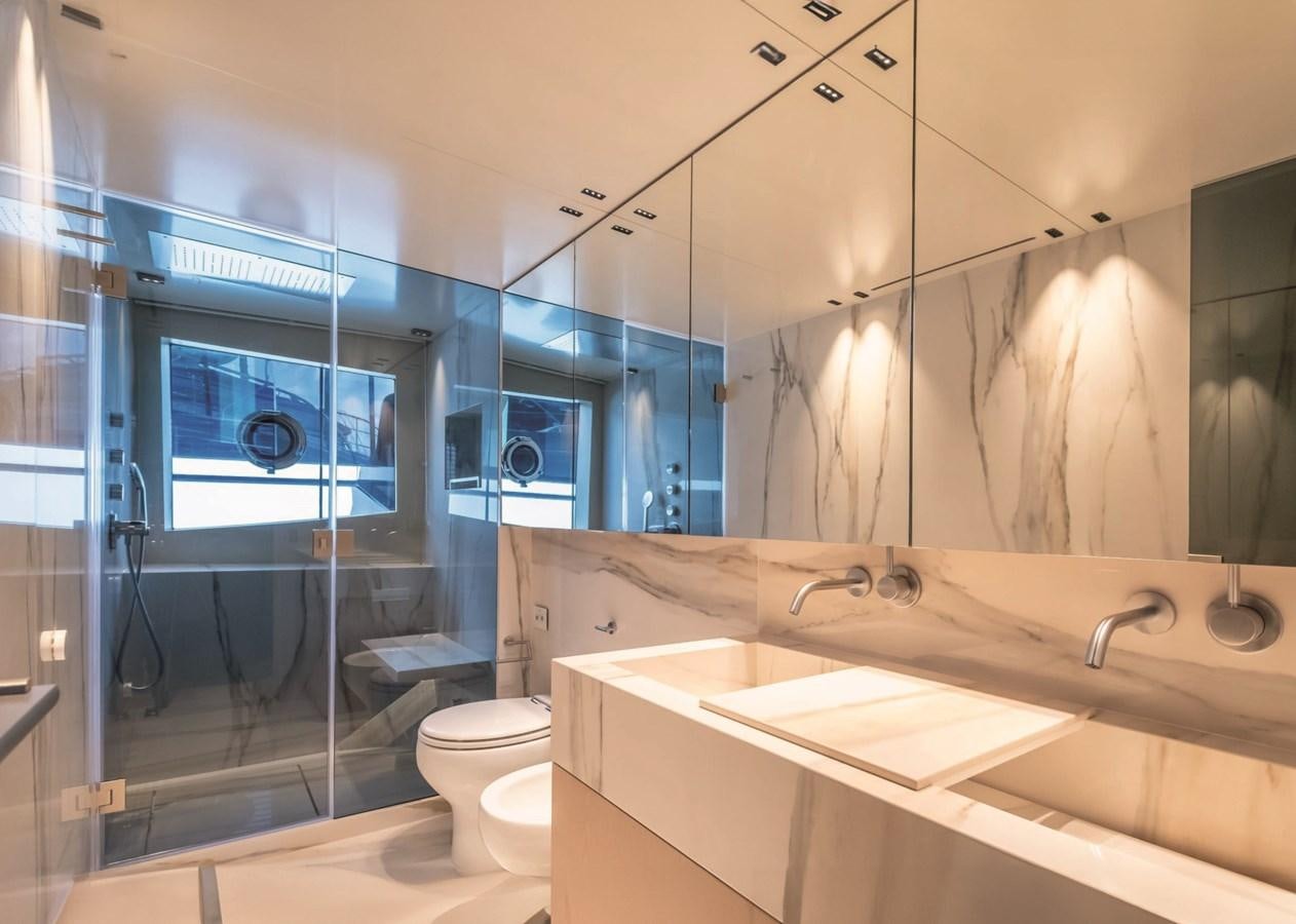a bathroom with a glass shower aboard NADA Yacht for Sale