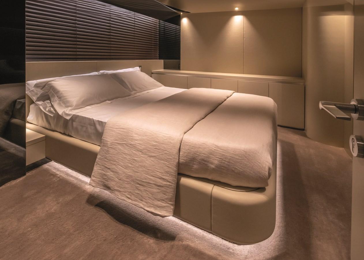 a bed with a white cover aboard NADA Yacht for Sale