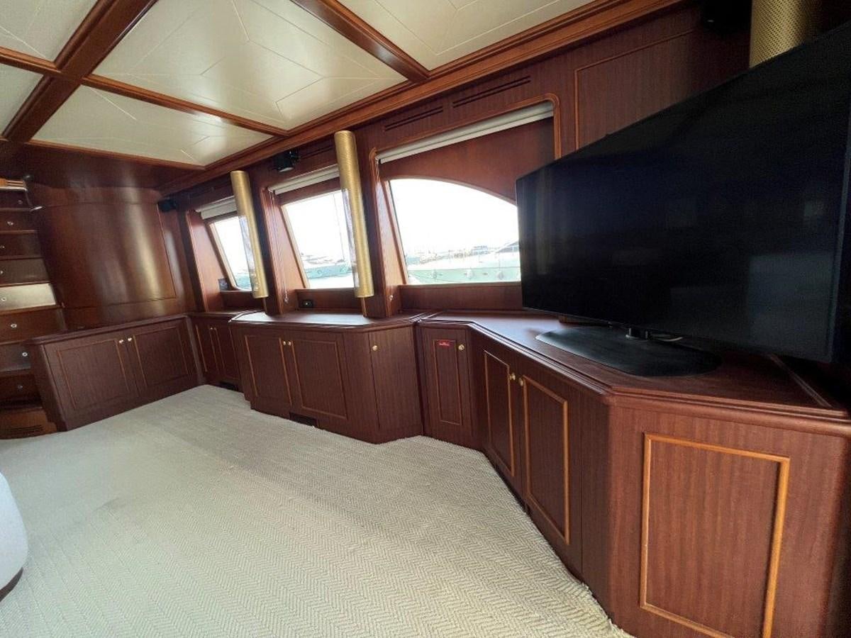 a bedroom with a large tv aboard MYEERAH Yacht for Sale
