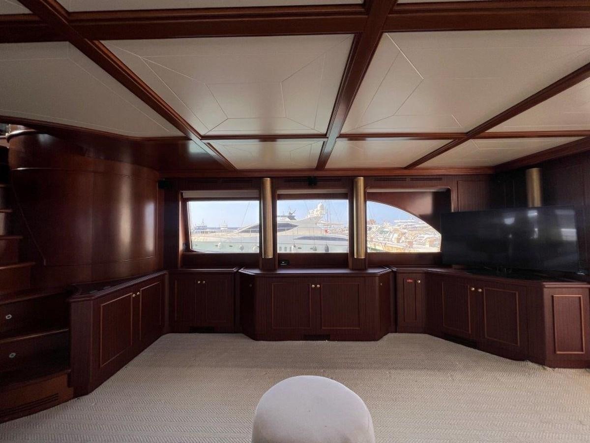 a room with a large window and wood cabinets aboard MYEERAH Yacht for Sale