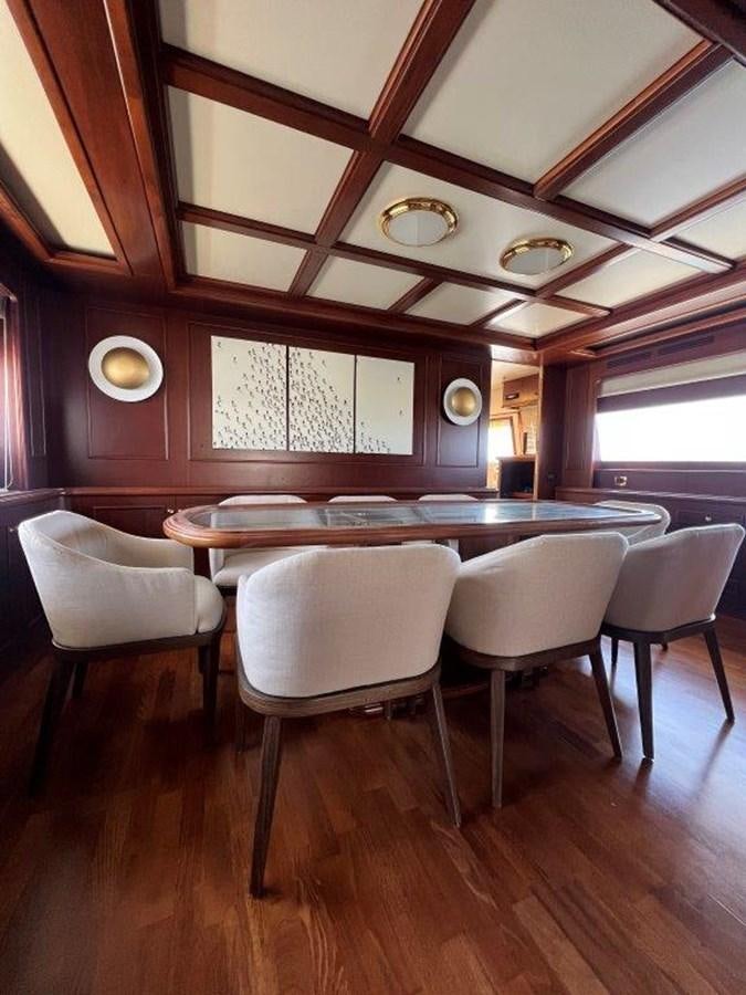 a room with a table and chairs aboard MYEERAH Yacht for Sale