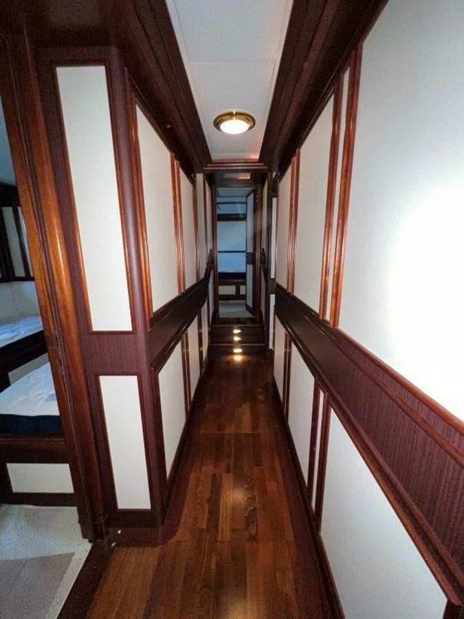 a wood staircase in a room aboard MYEERAH Yacht for Sale