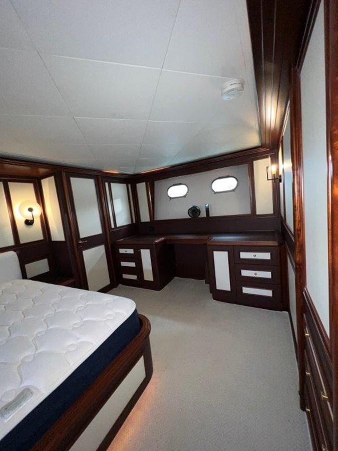 a room with a bed and a desk aboard MYEERAH Yacht for Sale