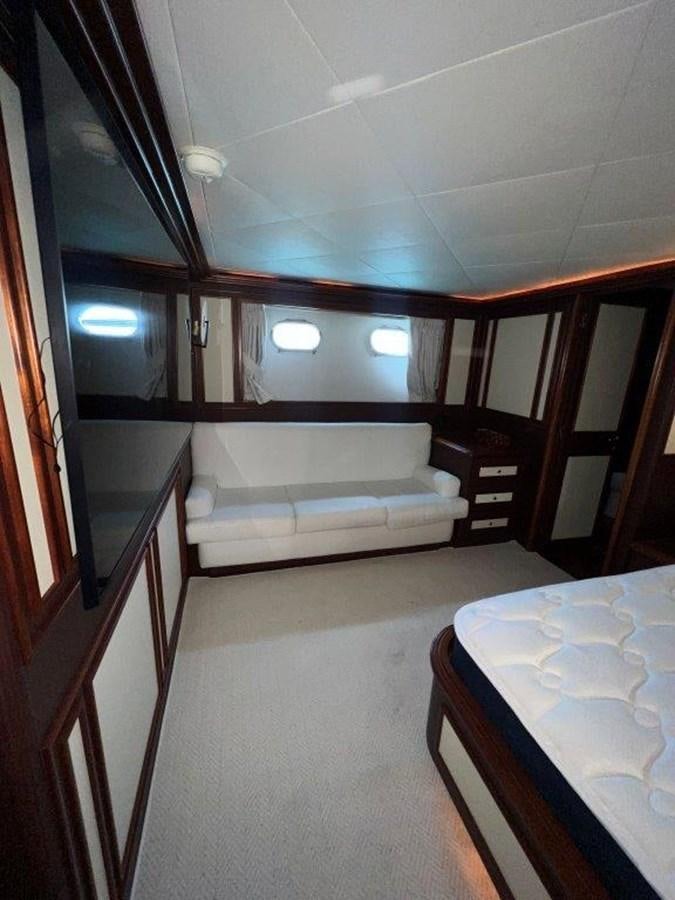 a room with a bed and a table aboard MYEERAH Yacht for Sale