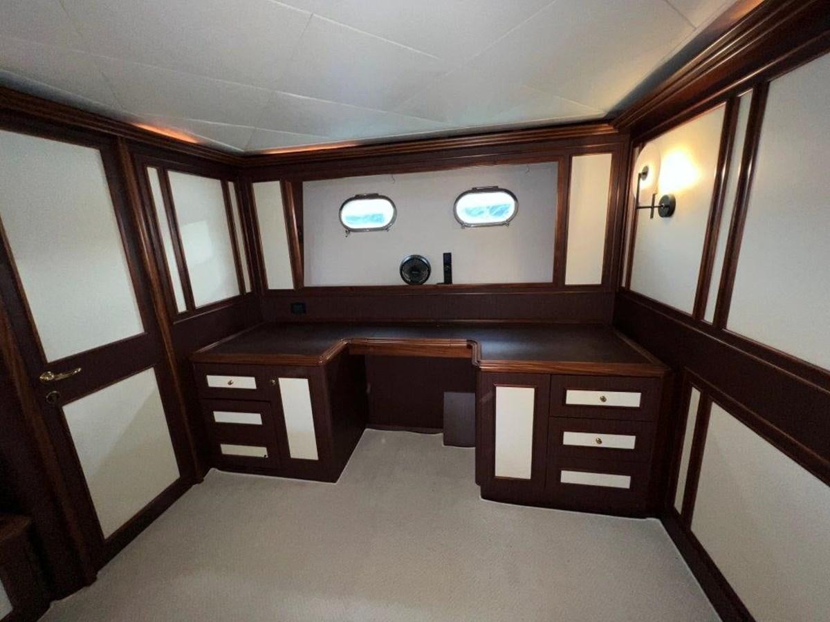 a room with a desk and a tv aboard MYEERAH Yacht for Sale
