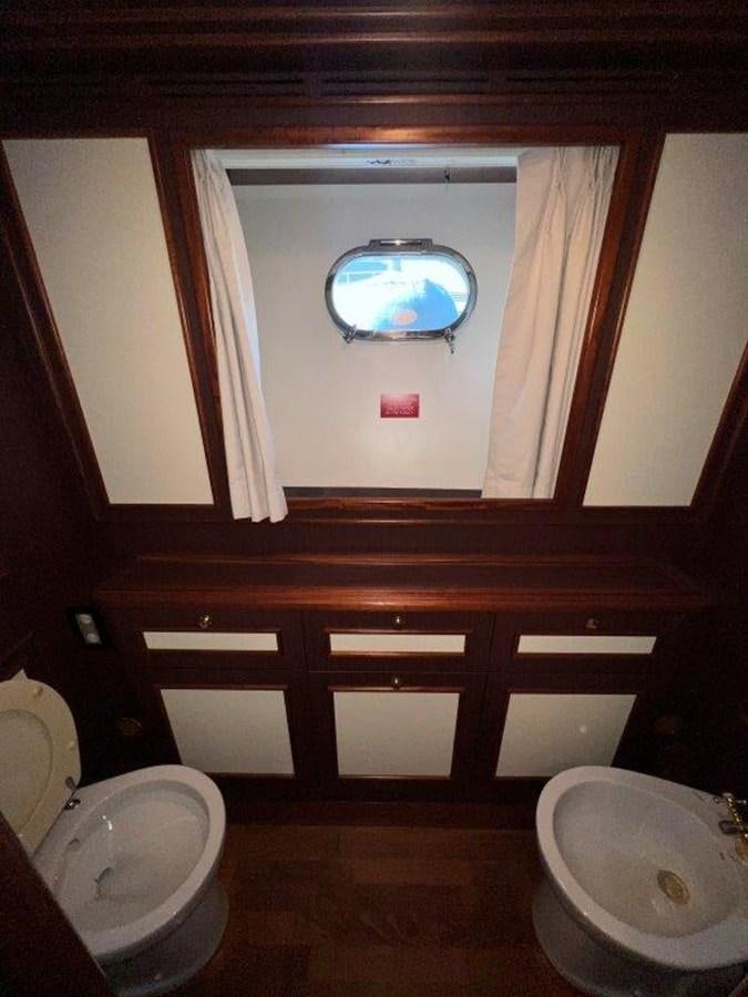a bathroom with a round mirror aboard MYEERAH Yacht for Sale