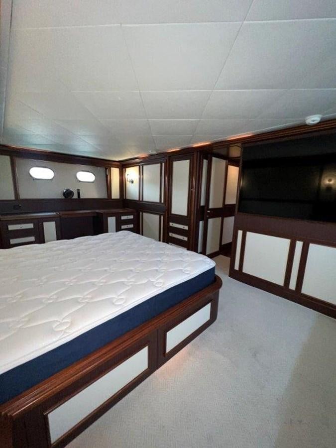 a room with a bed and a desk aboard MYEERAH Yacht for Sale