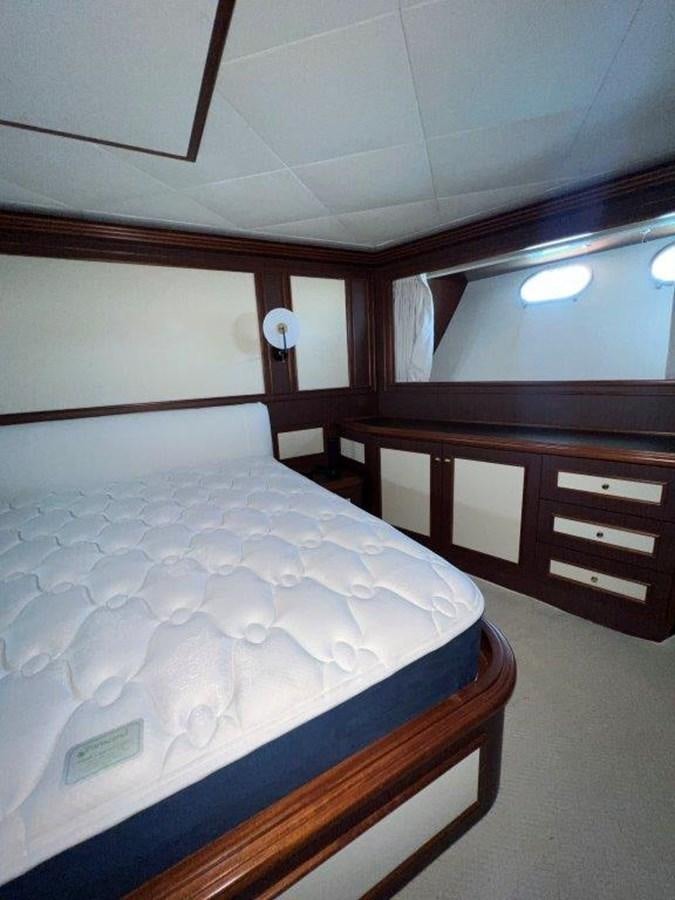 a bed with white sheets aboard MYEERAH Yacht for Sale