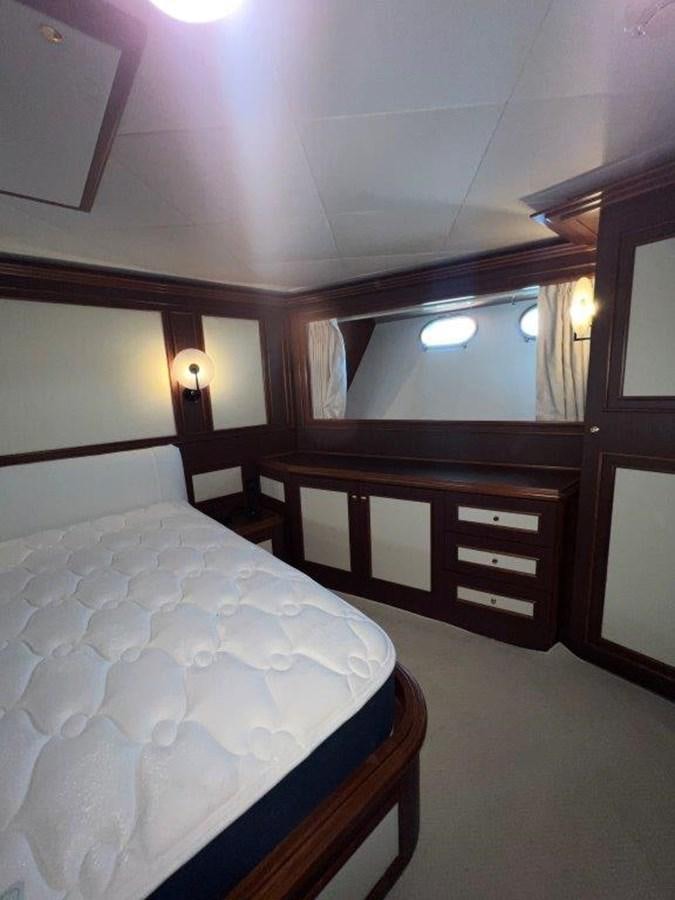 a bed with white sheets aboard MYEERAH Yacht for Sale