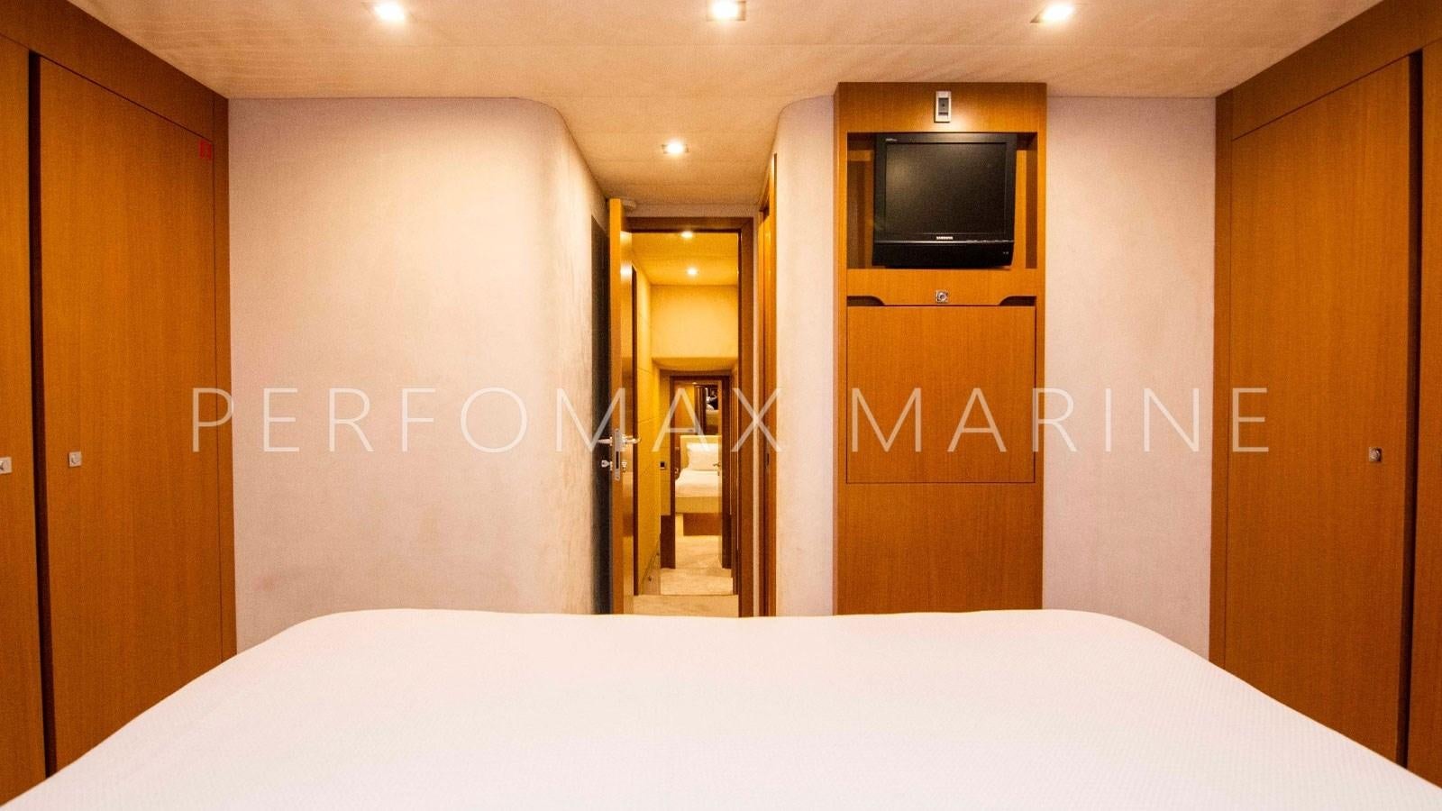 a room with a bed and a television on the wall aboard F78 Yacht for Sale
