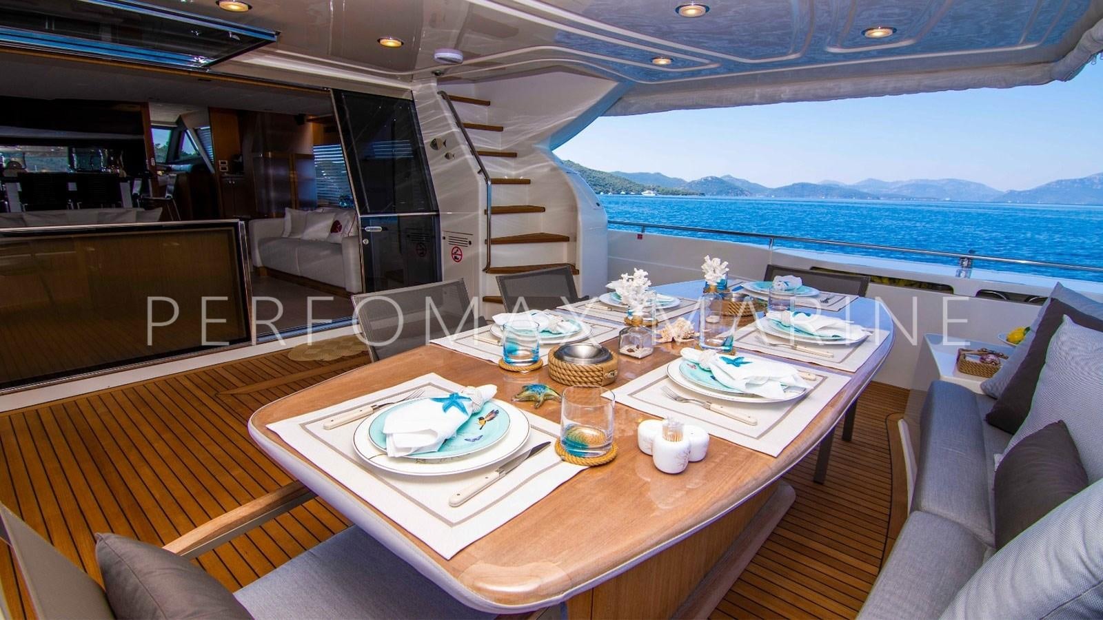 a table with food and drinks on it aboard F78 Yacht for Sale